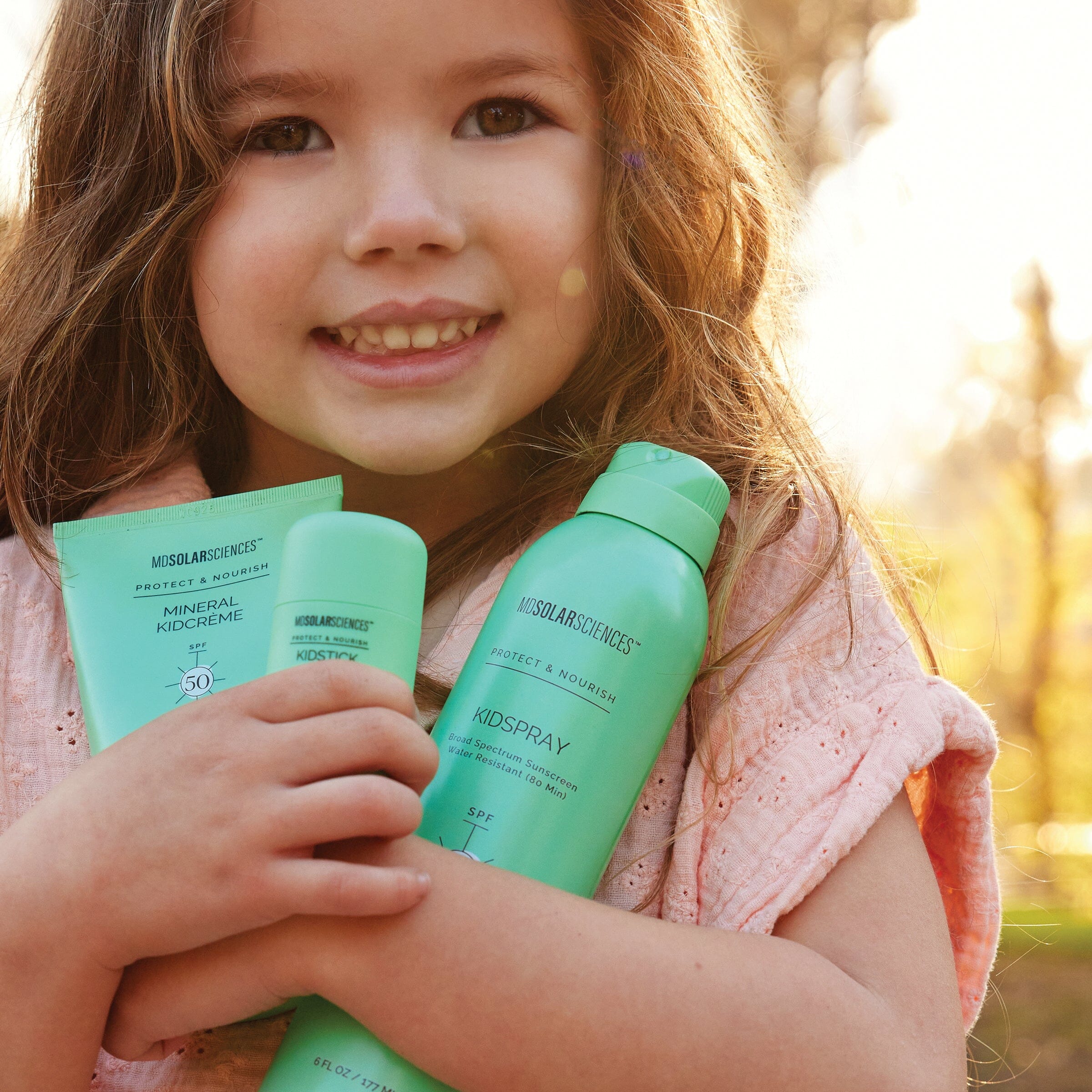 little girl holding her mineral sunscreen from MDSolarSciences
