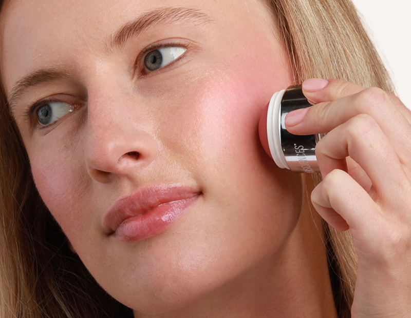 model applying cheek creme