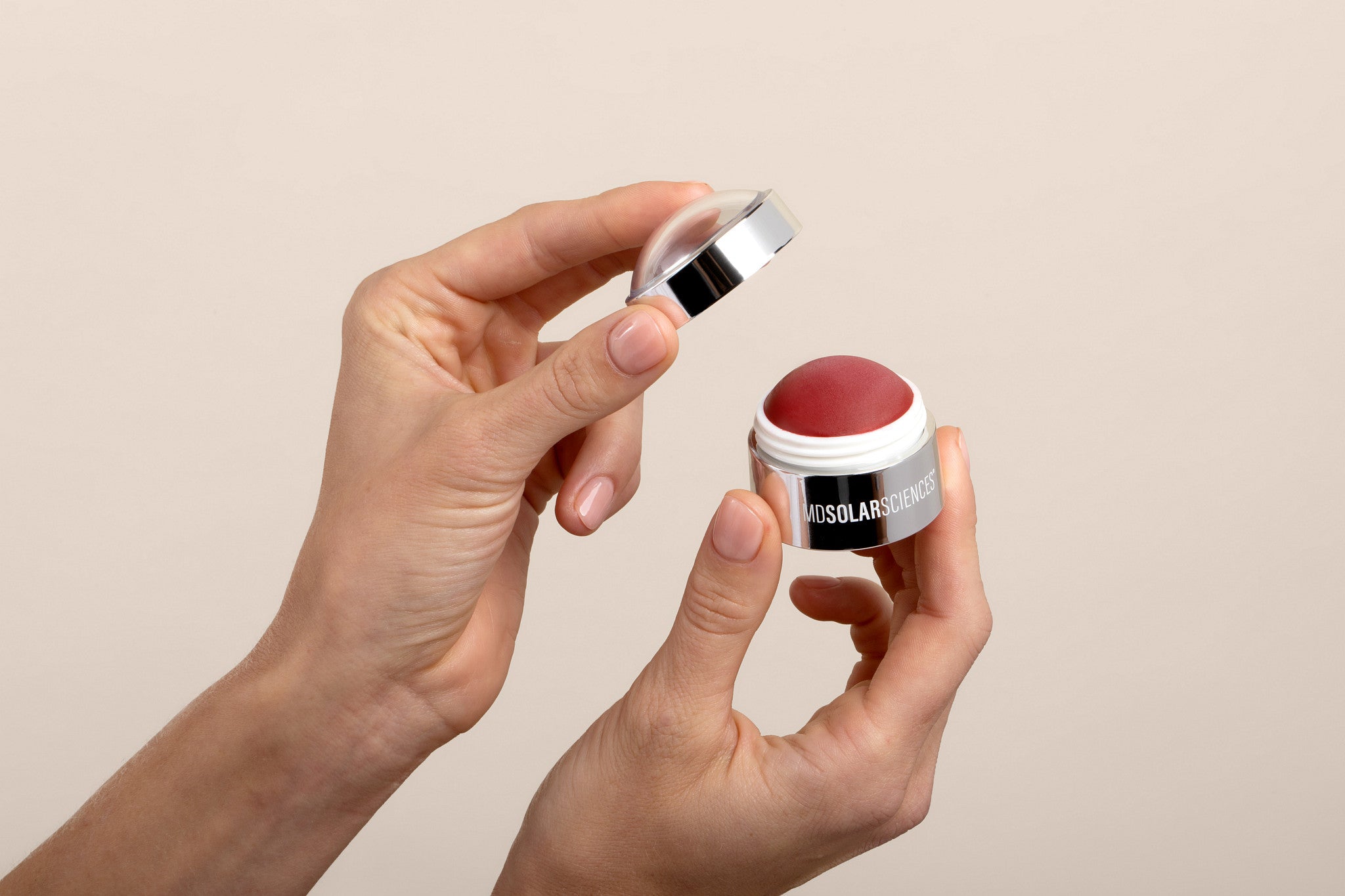 hands holding cheek creme