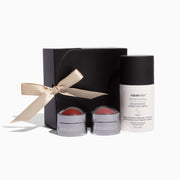 Cosmetic set with three jars and a black box featuring a bow on a white background